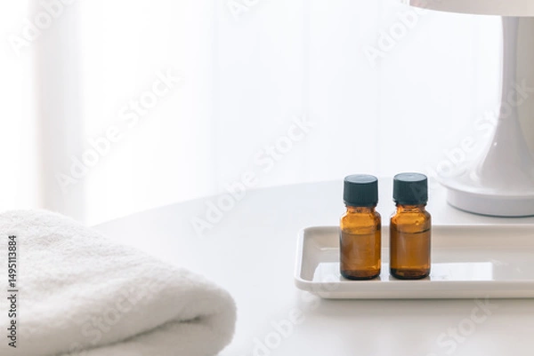 Obraz Minimalist Interior with Amber Aromatherapy Bottles on White Table