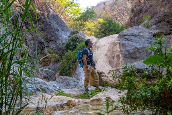 Obraz Tourist enjoying the scenic beauty of la magdalena waterfalls in tlatlauquitepec