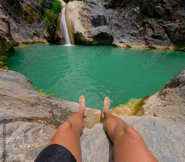 Obraz Tourist relaxing by the turquoise pond with waterfall in puebla, mexico