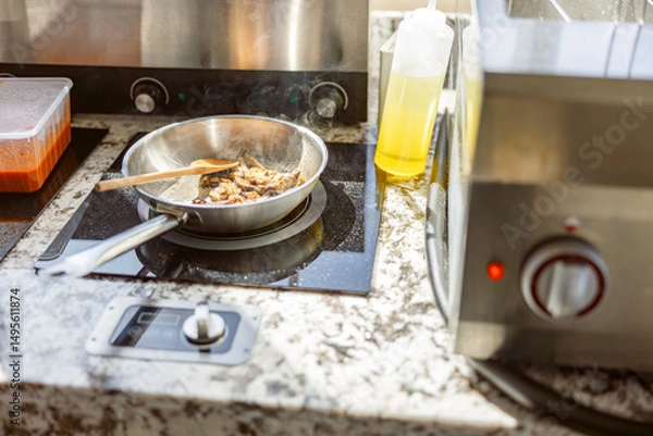 Obraz A stylish kitchen scene with a frying pan, fresh ingredients, and essential tools for culinary delights