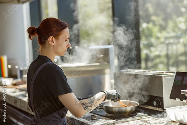 Obraz A passionate chef skillfully prepares delicious meals in a stylish kitchen, showcasing their culinary artistry