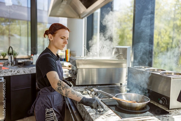 Obraz A talented chef skillfully prepares delicious dishes in a bright, contemporary kitchen filled with steam