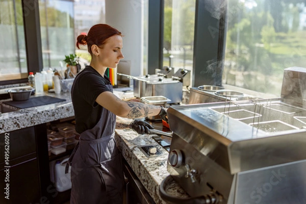 Obraz A barista expertly prepares beverages in a bright, contemporary caf setting
