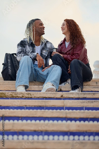 Fototapeta Couple enjoying a joyful moment together on steps in a vibrant outdoor location