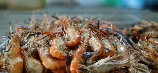 Obraz Freshly Caught Shrimp Pile Ready for Seafood Preparation and Cooking in a Rustic Kitchen Setting