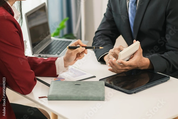 Obraz Businesswoman talking to business consultant to make decision on new business investment to make more productive and consultant also give advice on statistics on customer demand including good profit.