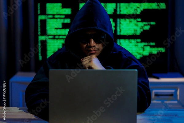 Fototapeta Cybercriminal hacking sensitive data in a dark room, reflecting the secretive and high-risk nature of digital threats in today’s online world.