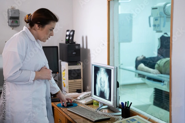 Fototapeta Radiologist Analyzing X Ray Scans in a Medical Imaging Room.