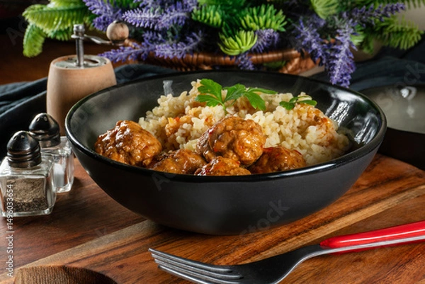 Fototapeta Meatballs pork and mashed potatoein paprika gravy served with groats bulgur.