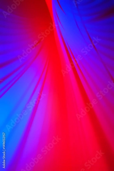 Fototapeta Abstract flowing fabric design with vibrant red and blue colors creating a dynamic feel
