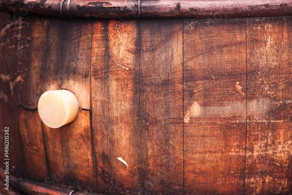 Obraz A wooden barrel with a cork inserted into it.