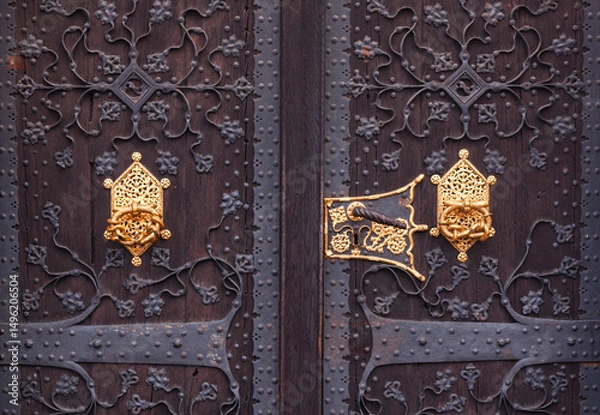 Obraz Antique wooden door with metal and gilded inserts.