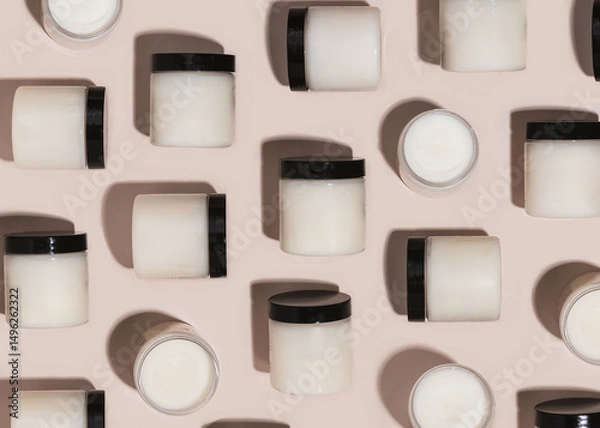 Fototapeta Repeating pattern of jars of beef tallow / shea butter jars on tan background 