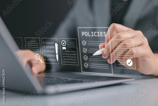 Fototapeta Policy documentation and compliance concept. Businessman reviews digital document Policies with icons, checklists, certifications, and financial detail. Policy management, regulatory compliance,
