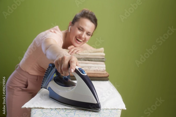 Obraz Joyful ironing close-up on olive green