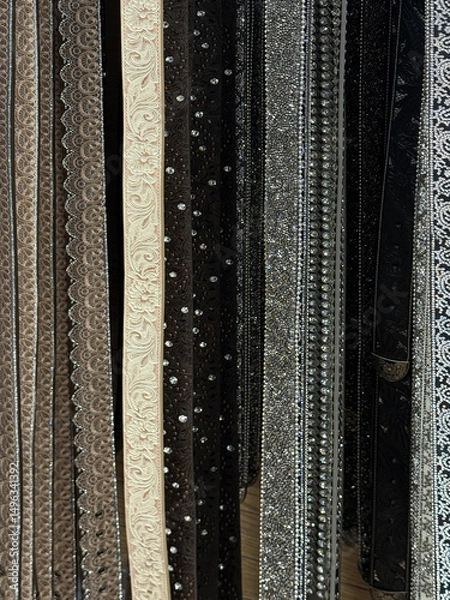 Obraz A selection of fashion leather belts hanging in a rack