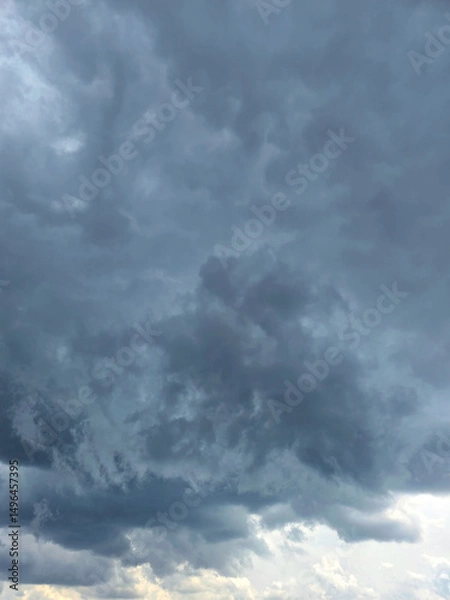 Obraz Dramatic Storm sky with dark blue and grey cumulus. Rainy clouds background texture. Just before the heavy rain or thunderstorm. dramatic dark clouds in the sky. Beautiful landscape with cloudy sky.