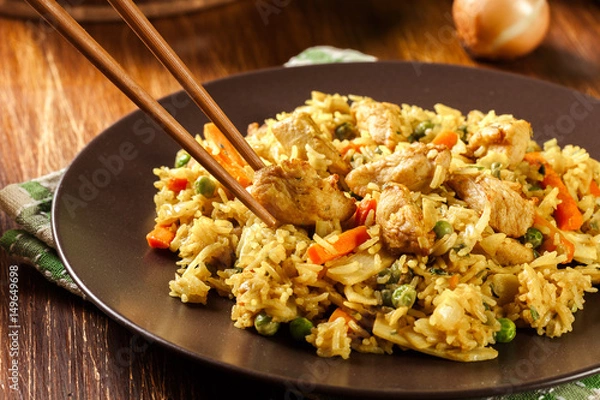 Fototapeta Fried rice nasi goreng with chicken and vegetables on a plate