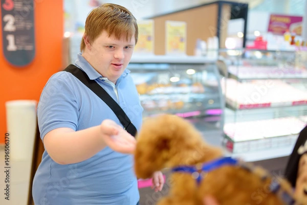 Fototapeta Boy with Down syndrome smiles while meeting passerby's dog.