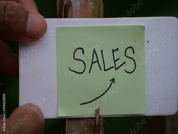 Fototapeta The word "sale" is boldly written on the hand, drawing attention for promotion purposes.
