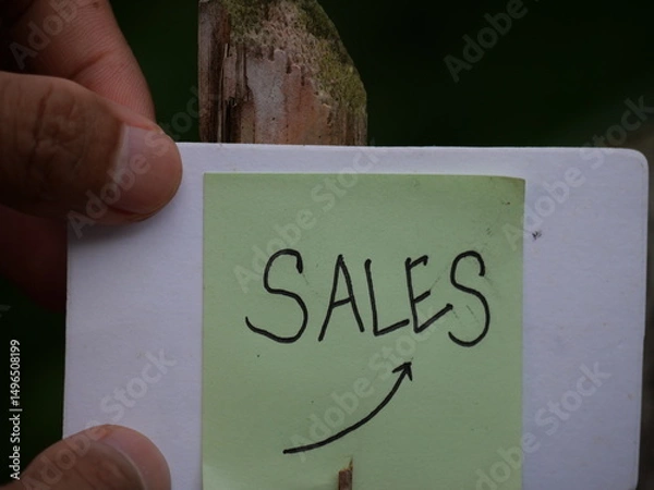 Fototapeta The word "sale" is boldly written on the hand, drawing attention for promotion purposes.