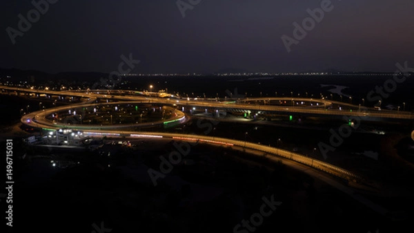 Fototapeta India's longest sea bridge: Trans-Harbour Sea Link. Atal Setu sea bridge in Mumbai, Maharashtra, India. Time-lapse of a city at night with bright skyscrapers and a dense network of glowing buildings.