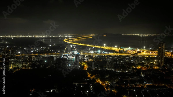 Fototapeta India's longest sea bridge: Trans-Harbour Sea Link. Atal Setu sea bridge in Mumbai, Maharashtra, India. Time-lapse of a city at night with bright skyscrapers and a dense network of glowing buildings.