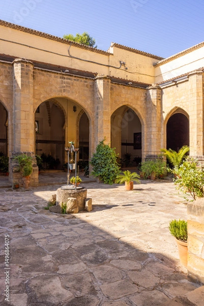 Fototapeta Cloister with arches and well in the Palace of Jabalquinto in Baeza, Spain