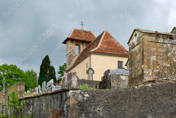 Fototapeta View of the White Penitents Chapel and cemetery on a hill near the village of Cornac Lot Occitanie in Southern France in summer under a cloudy sky	