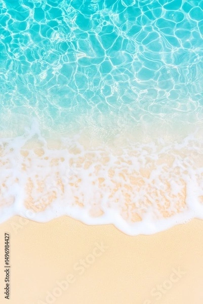 Fototapeta Beach shoreline with turquoise ocean waves washing onto yellow sand viewed from above. Aerial beach image for banner with copy space. Summer vacation and tropical paradise concept.