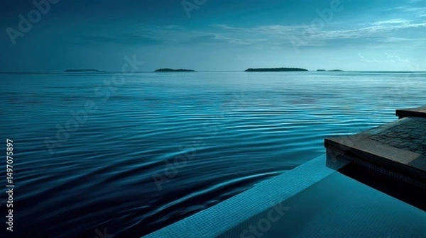 Fototapeta Soft blue tones and calm sea from a Maldives villa. Distant islands in hazy light create a dreamy romantic vista.
