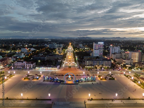 Fototapeta Vinh city skyline at dusk highlighting Nguyen Tat Thanh square and surrounding urban landscape