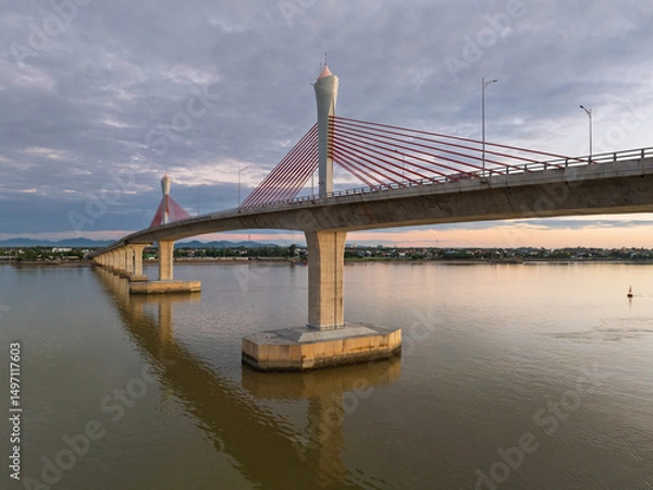Fototapeta Cua Hoi bridge spans tranquil waters in Vinh city, showcasing modern engineering in Nghe An province, Vietnam