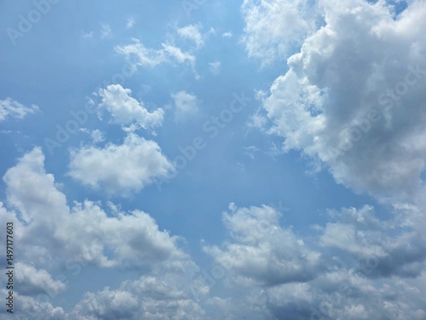 Obraz Beautiful sky with cumulus clouds. Blue sky clouds background, beautiful landscape with clouds. Clear blue sky and white clouds. High resolution wallpaper. Sunny day. Clean blue sky for background.