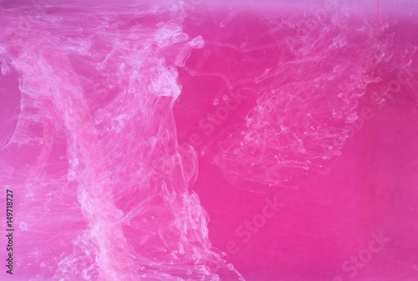 Fototapeta Abstract colored background. Pink smoke, ink in water, the patterns of the universe. Abstract movement, frozen multicolor flow of paint. Horizontal photo with soft focus, blurred backdrop.