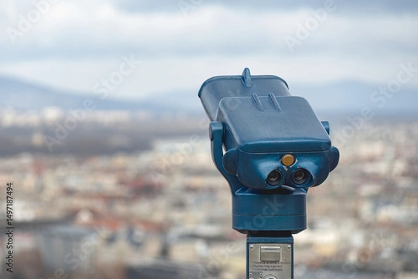 Obraz Blue tourist binoculars overlooking the cityscape of Budapest on a cloudy day