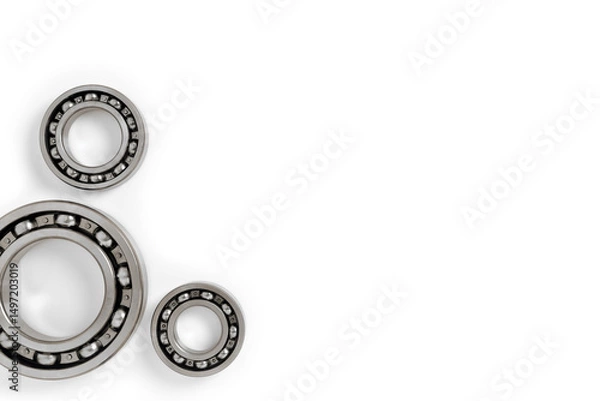 Fototapeta ball bearings on a white background, top view, blank for creativity. Parts for machines and mechanisms in rotation units. copy space