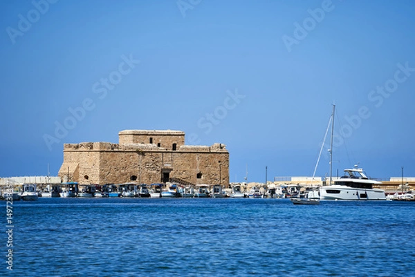 Obraz ruins of a medieval stone castle and motor boats in the port of Paphos
