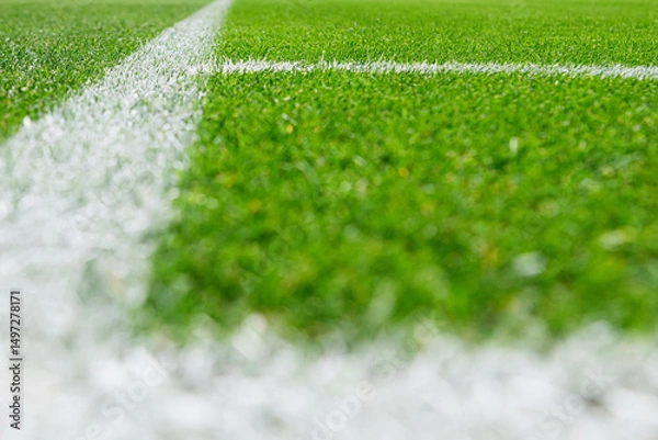 Fototapeta Close-up view of corner line, football, soccer field, with sharp white markings on well-maintained green grass.