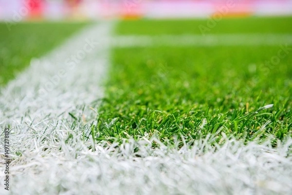 Fototapeta Close-up view of corner line, football, soccer field, with sharp white markings on well-maintained green grass.