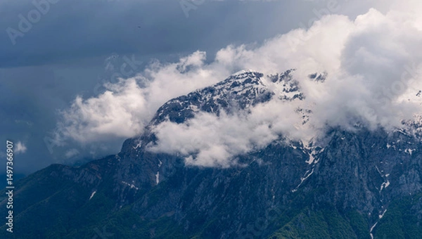 Fototapeta Moody panorama capturing the rugged summits of Grigna Settentrionale and Pizzo della Pieve emerging dramatically from a thick blanket of clouds, highlighting their alpine isolation. Lombardy