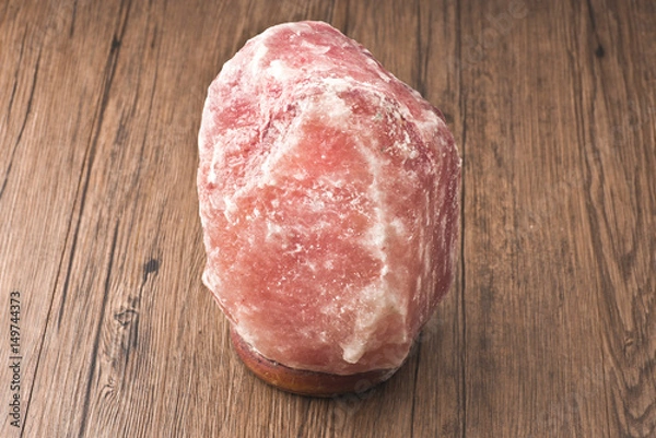 Fototapeta Pink salt lamp isolated on wood table