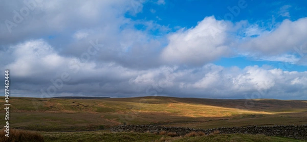 Fototapeta View across the hills at Teesdale with sunlit area on the hills.