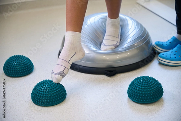 Fototapeta Close-up view of patients feet standing on soft balance pad