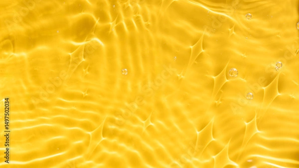 Obraz Abstract background of yellow water with ripples under sunlight. Top view, copy space. 