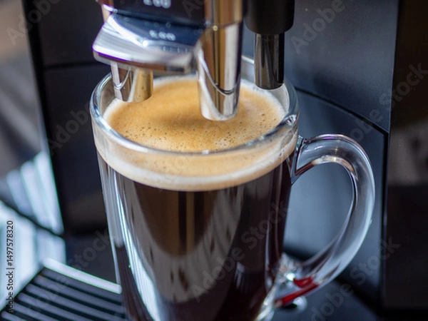 Fototapeta Coffee machine and glass mug with fragrant coffee. Coffee in the morning in a glass mug. Breakfast or lunch drink. Choosing a quality coffee machine