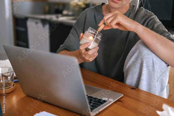 Obraz  Gen Z woman working from home at cozy kitchen table with laptop and phone. Digital nomad lifestyle, mindfulness, remote work, balance, mental calm and modern freelancing