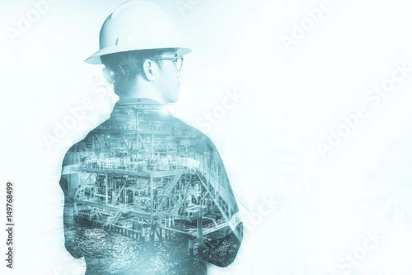 Fototapeta Double exposure of Engineer or Technician man with safety helmet operated platform or plant by using tablet with offshore oil and gas platform background for oil and gas business concept
