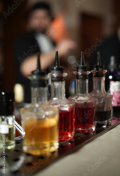 Fototapeta Liqueur Bottles on a Bar Counter, close-up