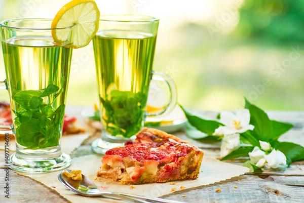Obraz Enjoying Refreshing Herbal Drinks and a Delicious Fruit Tart on a Bright Sunny Day